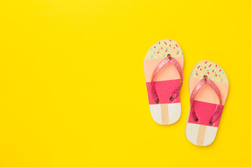 Bright flip flops on color background, top view