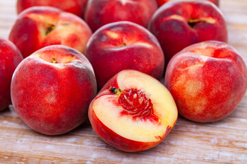 Fototapeta na wymiar Group of fresh sweet peaches on wooden table
