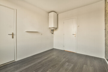 an empty room with wood floors and white doors on either side, there is no one person in the room