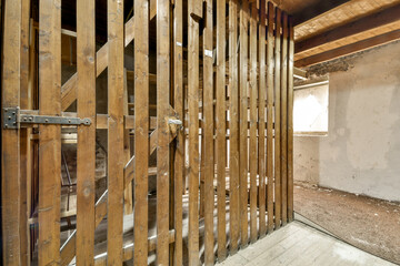 an unfinished room with wood sls on the walls and flooring boards in place to be used for construction purposes