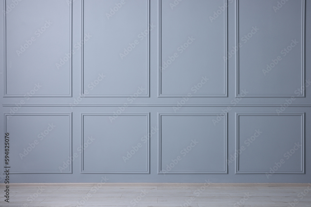 Poster Empty room with light blue wall and wooden floor