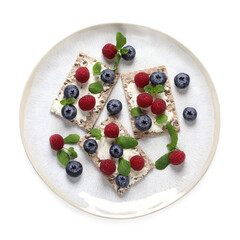 Plate with tasty crispbreads, berries and mint on white background, top view