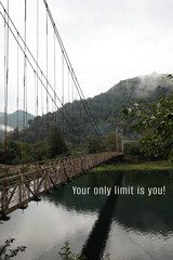 Your only limit is you, affirmation. Rusty metal bridge over river in mountains