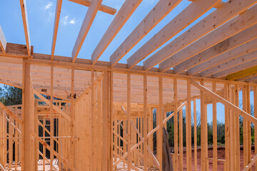 An enclosing beam supports framework of layout joists in newly constructed wooden structure.