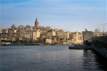 Fototapeta premium View of Beyoglu district with Galata Tower and Galata Bridge from the waters of the Golden Horn Bay on a sunny day, Istanbul, Turkey