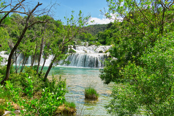 Beautiful Waterfall background in sunny summer day. Beautiful Waterfall In Krka National Park - Croatia, Europe. Krka river waterfalls in the Krka National Park