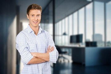 Portrait of a young businessman standing in the office,