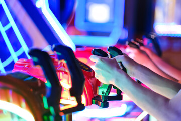 Kids playing arcade video games. Close up of hands controlling joystick.