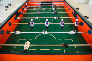 Fototapeta premium A foosball table is a recreational game symbolizing entertainment, skill, and socializing. It represents teamwork, competition, and the joy of play, and is often associated with bar and culture