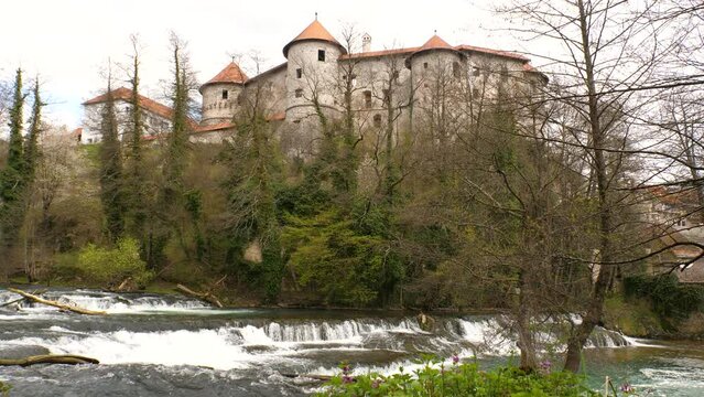 Static shot of Zuzemberk Castle with the Krka river rapids below