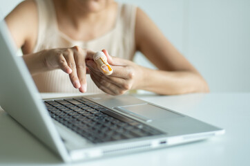 Woman using plastic finger splint on a broken fingers support to relieve pain