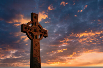 Christian cross on hill outdoors at sunrise. Resurrection of Jesus. Concept photo. Selective focus.