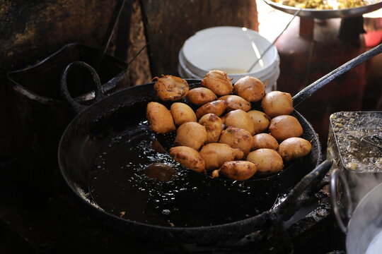 Frying Kachori in a Frying Pan at a street food stall , oily food