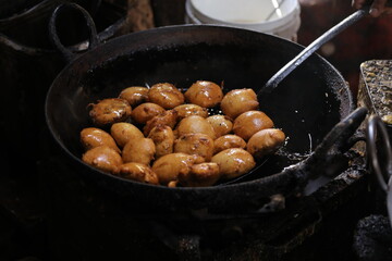 Frying Kachori in a Frying Pan at a street food stall , oily food