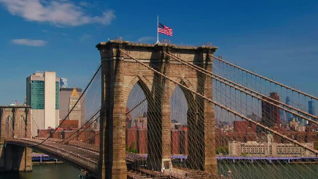 Brooklyn Bridge traffic American Flag NYC Downtown Manhattan Buildings FDR Drive traffic East River Waterfront Summer Day Aerial View