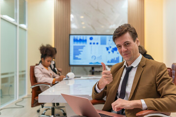 Young handsome successful businessman with different poses in a meeting room. Team lead in a meeting room. Manager at work.