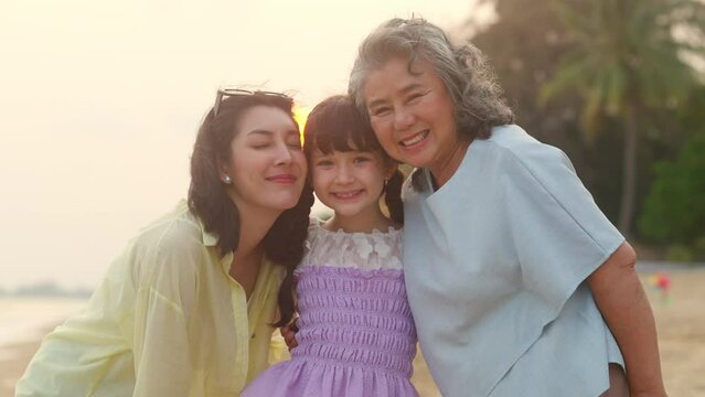 4K Portrait group of Happy Multi-Generation Asian women family enjoy and fun outdoor lifestyle walking and playing together at tropical beach at sunset during travel ocean on summer holiday vacation.