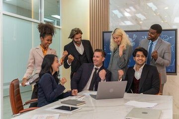 Group of businessmen and businesswomen cheers to celebrate their latest successful deal in a office meeting room