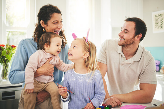 Parents, girl children and bunny ears in family home with funny face, baby or happiness for easter. Man, woman and kids in house, laughing and excited for christian holiday with love, care or bonding