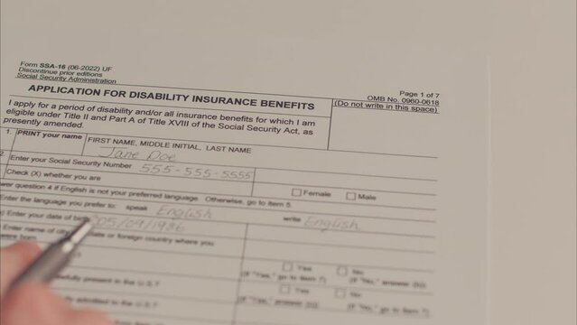 Caucasian Female Hand Filling Out Application For Disability Insurance Benefits. Shot with ARRI Alexa in ARRIRAW and exported QuickTime Apple ProRes 422 HQ.