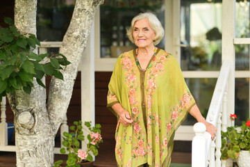 A beautiful elderly walks near their house 