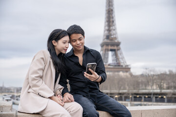 Couple enjoy beautiful view of Paris and Eiffel Tower,  vacation in France.