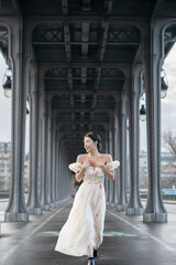 Woman portrait under Bir Hakeim bridge. Paris, France.