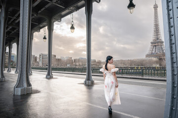 woman portrait under Bir Hakeim bridge with Eiffel tower. Paris, France.