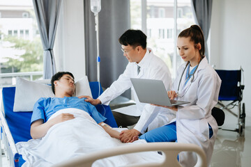 Obraz premium Two doctors talking to a patient lying in his bed with receiving saline solution in hospital .