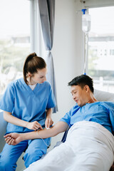 Fototapeta premium Caucasian doctor smiling take care of a young patient in hospital. Friendly nurse or therapeutic treat client Professional medical service concept.