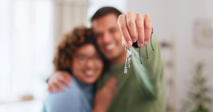 Hand, keys and a home owner couple proud of their real estate property investment or purchase. House, mortgage or beginning with a blurred background man and woman together in their new apartment