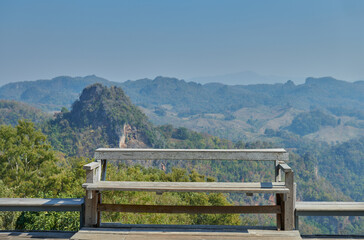 Empty bench with mountain landscape background. Tranquil scene.