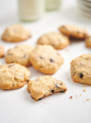 Homemade butter cookies with chocolate chips on white wooden table, copy space. Healthy vegan cookies.