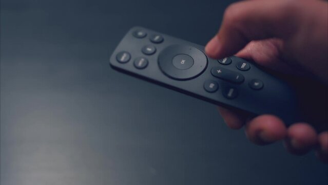 Latino Male Turning Volume Up, Then Down on Remote Control. Shot with ARRI Alexa in ARRIRAW and exported QuickTime Apple ProRes 422 HQ.