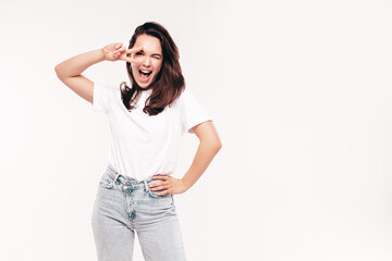 Young beautiful smiling female in summer jeans and white t-shirt. Sexy carefree woman isolated on...