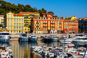 Nice port with yachts, boats and pierces in Nice Port and yacht marina district with Colline du Chateau Castle hill on French Riviera in France