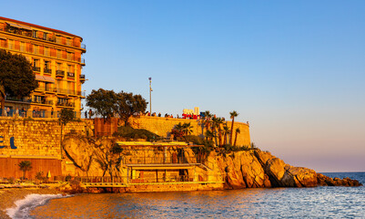 Sunset view of Colline du Chateau Castle Hill, Vieille Ville Castel Beach and Tour Bellanda Tower in Nice on French Riviera of Mediterranean Sea in France - obrazy, fototapety, plakaty