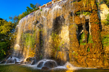Medieval waterfall off rocky cliff of Colline du Chateau Castle Hill over Mediterranean Sea shore...