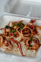 stir fried holy basil with octopus or squid and herb - Asian food style