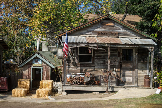 old farm house with wheels and rural tools