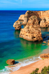 beautiful sandy beach with rocks formation in the atlantic ocean- Algarve in Portugal