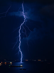 Lightning striking the sea at night.