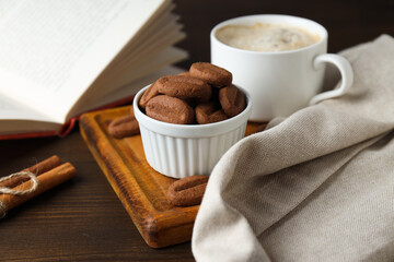 Concept of tasty snack for hot drink - cookies in the shape of coffee seeds