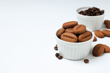 Concept of tasty snack for hot drink - cookies in the shape of coffee seeds