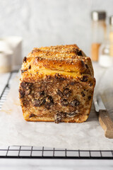 Yeast pull-apart bread with cream cheese, chocolate, prunes, chocolate and nuts. Front view, homemade baking, cutaway piece.
