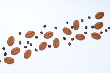Concept of tasty snack for hot drink - cookies in the shape of coffee seeds