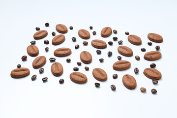 Concept of tasty snack for hot drink - cookies in the shape of coffee seeds