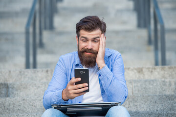 Loser in betting. Frustrated man lost mobile bet. Making bet in mobile device. Betting online