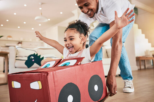 Car, cardboard and father playing child in fantasy game bonding in a living room or home lounge together. Happiness, happy and single parent or dad having fun with kid or daughter excited to play