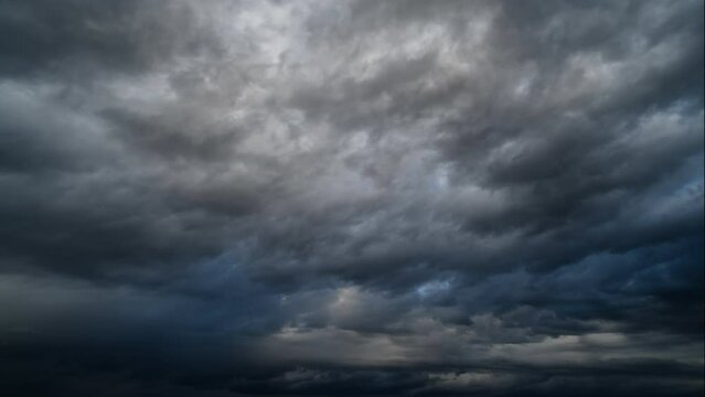 storm sky timelapse - dark dramatic clouds during thunderstorm, rain and wind, extreme weather, abstract background
